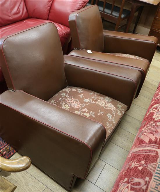 A pair of leather club chairs